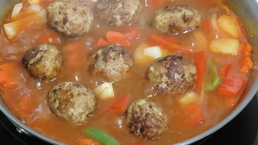 simmering meatballs and sauce