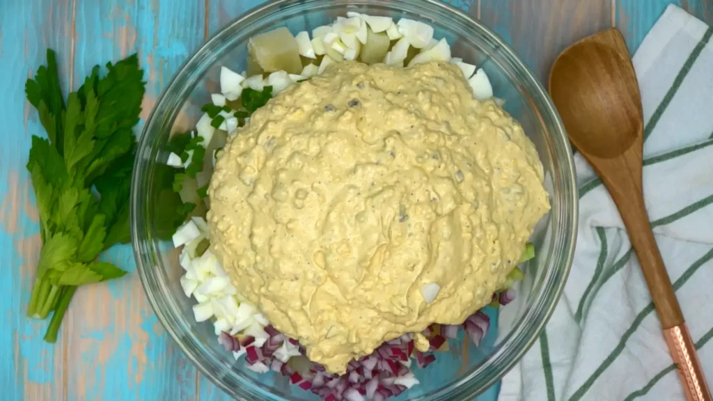 mixing ingredients of Devilled Egg Potato Salad