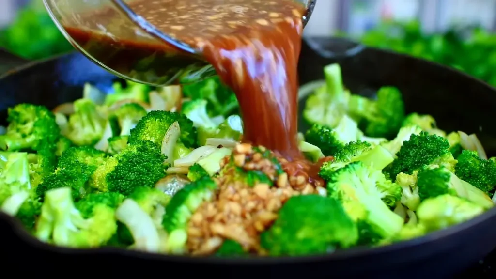 pouring sauce over beef and broccoli