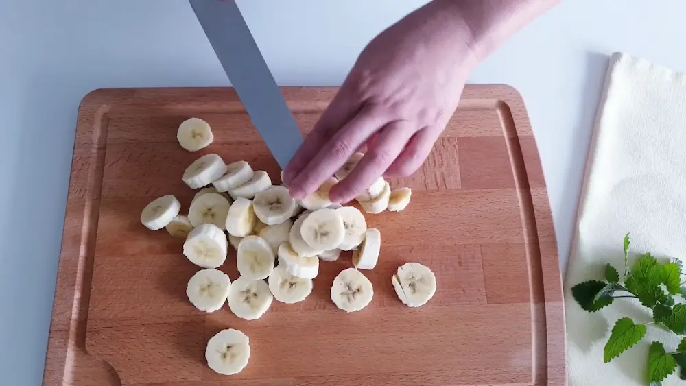 Cutting bananas into small pieces for banana yogurt cake