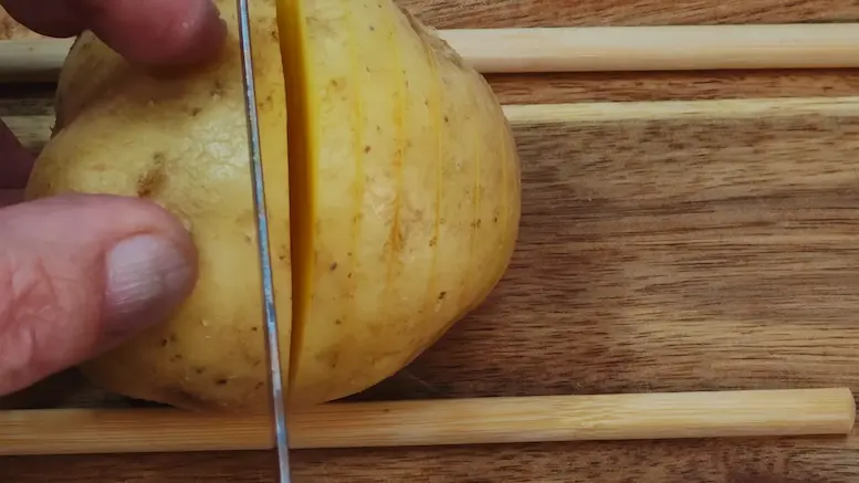 cutting potatoes for making Hassleback Potatoes